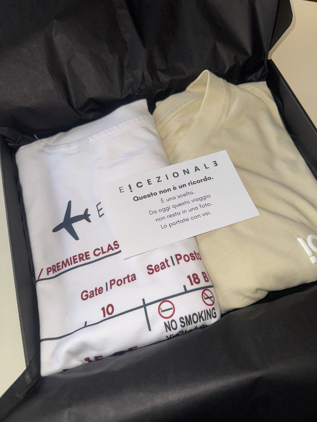 TravelBox aperto con le due TravelTee personalizzate e la card di benvenuto E!CEZIONALE